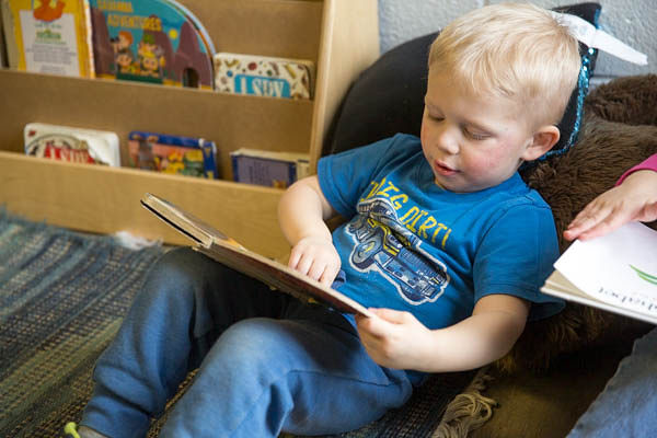 Orchard Hill Preschool Classroom with Student Looking at Books